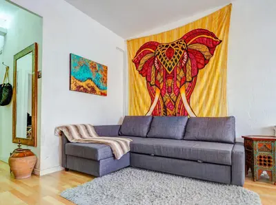 a living room with a couch and a painting of an elephant at Araia Apartment by Hello Homes Sitges in Sitges
