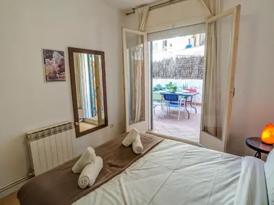 a bedroom with a bed with white towels on it at Araia Apartment by Hello Homes Sitges in Sitges