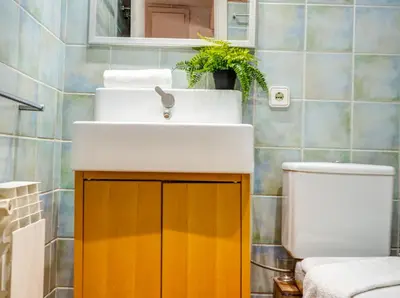 a bathroom with a sink and a toilet at Araia Apartment by Hello Homes Sitges in Sitges