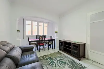 a living room with a couch and a table at Bed&BCN Mas Apartments in Hospitalet de Llobregat