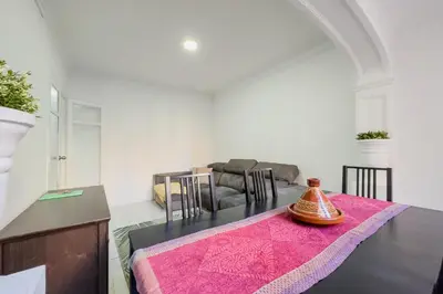 a living room with a table and a couch at Bed&BCN Mas Apartments in Hospitalet de Llobregat