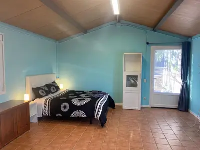 a bedroom with a bed in a room with blue walls at La Geneta Casa Vacacional in Vilobi Del Penedes