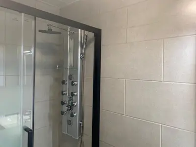 a shower with a glass door in a bathroom at La Geneta Casa Vacacional in Vilobi Del Penedes