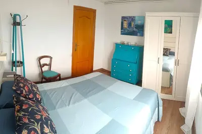 a bedroom with a blue bed and a blue dresser at Apartamento al lado de Barcelona y la playa in Montgat