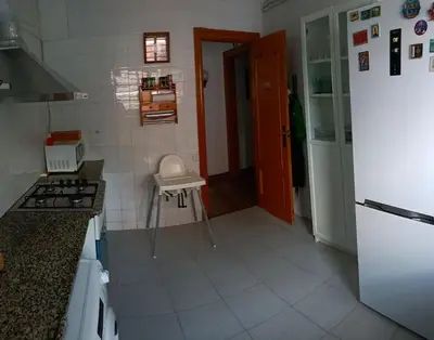 a kitchen with a stove and a white refrigerator at Apartamento al lado de Barcelona y la playa in Montgat