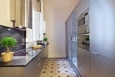 a kitchen with a counter with a sink and a microwave at My Space Emirates - Apartments in Rambla de Catalunya in Barcelona