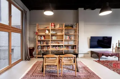 a living room with a table and two chairs at Loft estilo industrial en Esplugues - 15 min de Barcelona in Esplugues de Llobregat