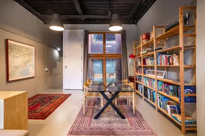 a room with a table and bookshelves at Loft estilo industrial en Esplugues - 15 min de Barcelona in Esplugues de Llobregat