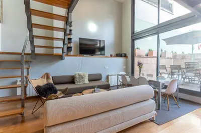 a living room with a couch and a table at My Space Emirates - Bright Apartment in Gracia with shared Pool in Barcelona