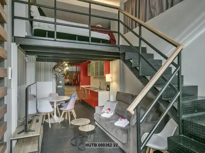a living room and kitchen with a loft conversion at Alcam Futbol Pequeño in Barcelona