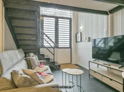 a living room with a couch and a flat screen tv at Alcam Futbol Pequeño in Barcelona