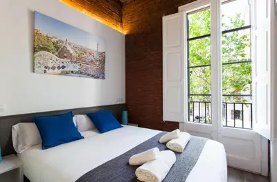 a bedroom with two beds and two windows at 2512 - AB Comte dUrgell P-II in Barcelona