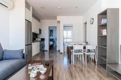 a living room and kitchen with a couch and a table at 2514 - AB Comte dUrgell V-II in Barcelona