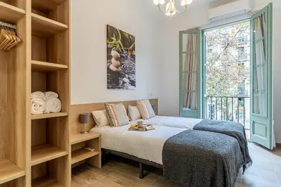 a bedroom with a bed and a large window at 4190 - AB Comte dUrgell P-I in Barcelona