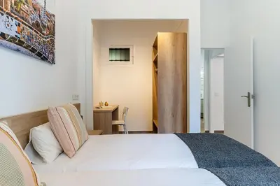 a bedroom with a white bed and a desk at 4190 - AB Comte dUrgell P-I in Barcelona