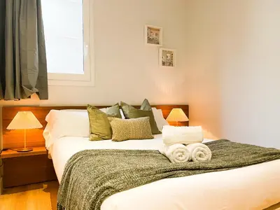 a bedroom with a bed with towels on it at Boutique Pare Lainez in Barcelona