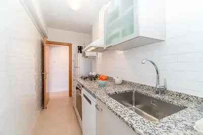 a kitchen with a sink and a counter top at Horizonte Azul Sitges in Sitges