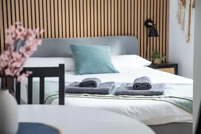a bedroom with a bed with towels on it at StayCampNou Studio with Balcony in Hospitalet de Llobregat