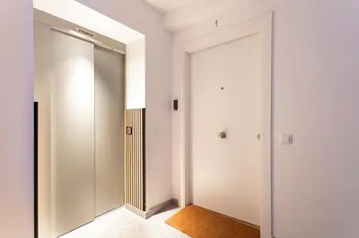 a hallway with a sliding door and a mirror at StayCampNou Studio with Balcony in Hospitalet de Llobregat