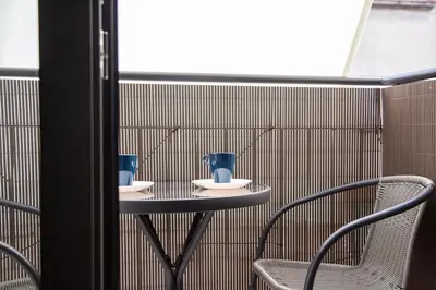 a small table with two blue vases on it at StayCampNou Studio with Balcony in Hospitalet de Llobregat