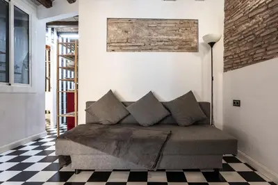 a couch in a room with a checkered floor at Apartamento La Boqueria 3 in Barcelona