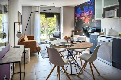a kitchen and living room with a table and chairs at Habitat Apartments Free Jazz in Barcelona