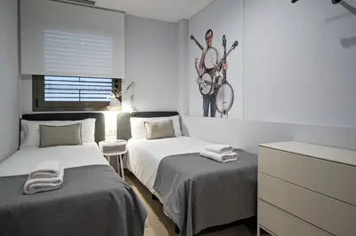 a bedroom with two beds with towels on them at Habitat Apartments Free Jazz in Barcelona