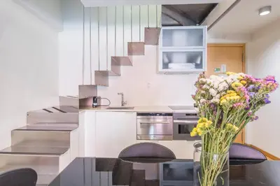 a kitchen with a table with a vase of flowers at My Space Emirates - Fully equipped apartments near the Beach with shared pool in Barcelona