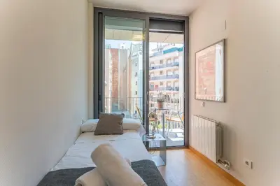 a living room with a couch and a large window at My Space Emirates - Fully equipped apartments near the Beach with shared pool in Barcelona