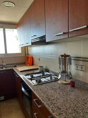 a kitchen with a stove and a blender on a counter at Apartamento a primera línea de Mar in Pineda de Mar