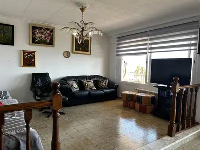 a living room with a couch and a television at Apartamento a primera línea de Mar in Pineda de Mar