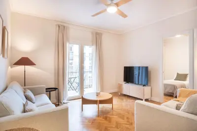 a living room with a couch and a tv at Warmth and comfort in the sought-after Eixample in Barcelona