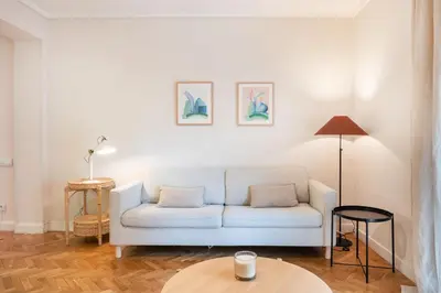 a living room with a couch and a table at Warmth and comfort in the sought-after Eixample in Barcelona
