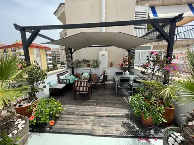 an outdoor patio with tables and chairs and plants at Preciosa casa en el centro con terraza y patio in Sitges
