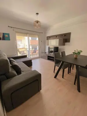 a living room with a couch and a table at Sitges Best Holidays Apartment in Sitges