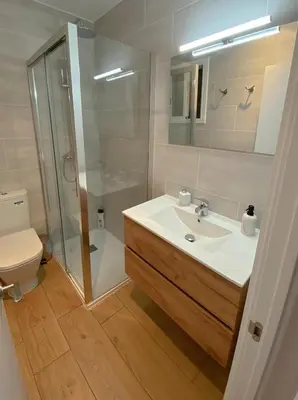 a bathroom with a sink and a shower and a toilet at Sitges Best Holidays Apartment in Sitges