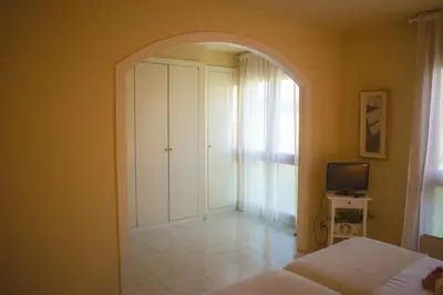 a bedroom with an archway with a bed and a television at Espectacular Casa en La Garriga in La Garriga