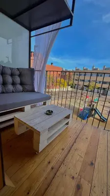 a couch and a table on a balcony at FIRA GRAN VIA II in Hospitalet de Llobregat