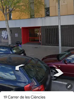 two cars parked in a parking lot in front of a building at FIRA GRAN VIA II in Hospitalet de Llobregat
