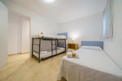 a bedroom with two bunk beds in a room at HomeHolidaysRentals Anais - Costa Barcelona in Pineda de Mar