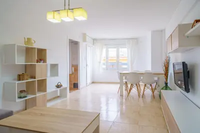 a kitchen and dining room with a table and chairs at HomeHolidaysRentals Anais - Costa Barcelona in Pineda de Mar
