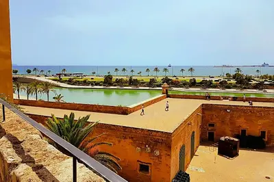 a building with a pool of water next to a beach at Holiday home in Calella de la Costa 3641 in Calella