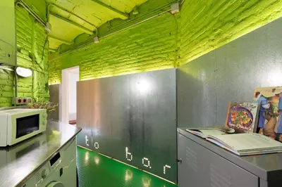 a kitchen with green walls and a counter with a microwave at Eulalias Lodges Barcelona in Barcelona