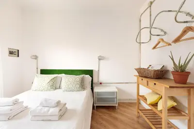 a bedroom with a bed with towels on it at Eulalias Lodges Barcelona in Barcelona