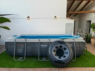 a hot tub with a large tire on the grass at Casa Cal Tòfol in Font-Rubí