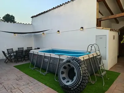 a pool with a large tire next to a patio at Casa Cal Tòfol in Font-Rubí