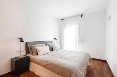 a bedroom with a large bed with a window at Enjoy Apartments Calle Paris Super Stylish in Barcelona