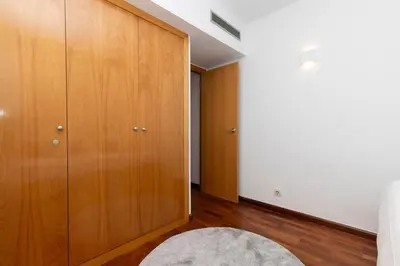 a bedroom with a wooden closet and a bed at Enjoy Apartments Calle Paris Super Stylish in Barcelona