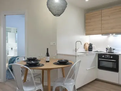a kitchen with a wooden table and chairs in a kitchen at ´Vicens Gem´ Private terrace HS Wi-Fi in Gracia by MyRentalHost in Barcelona