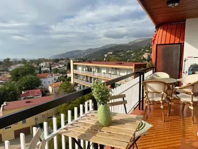 a vase sitting on a wooden table on a balcony at Atico Isabel in Castelldefels